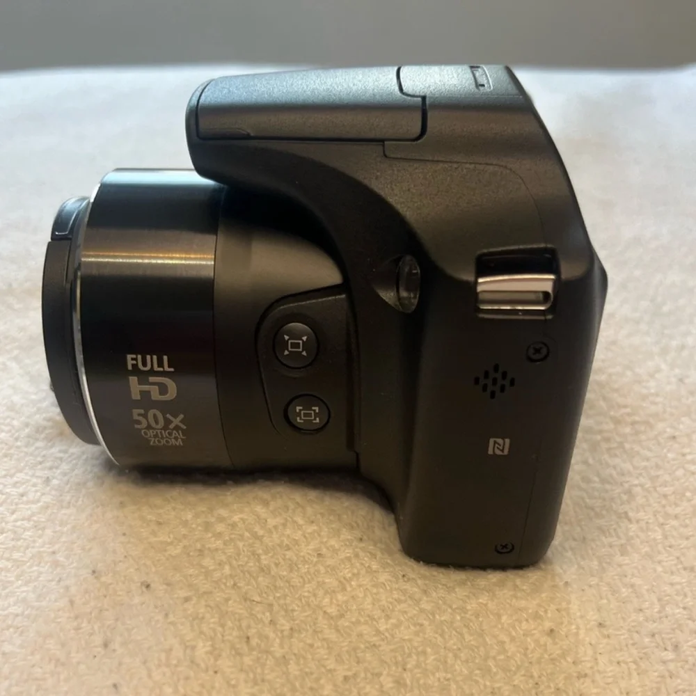 Canon Black Digital Camera with Large Zoom Lens and Textured Grip